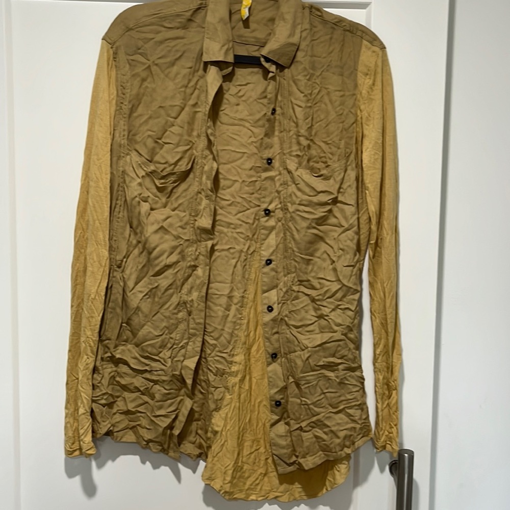 Gold blouse with knit inserts.